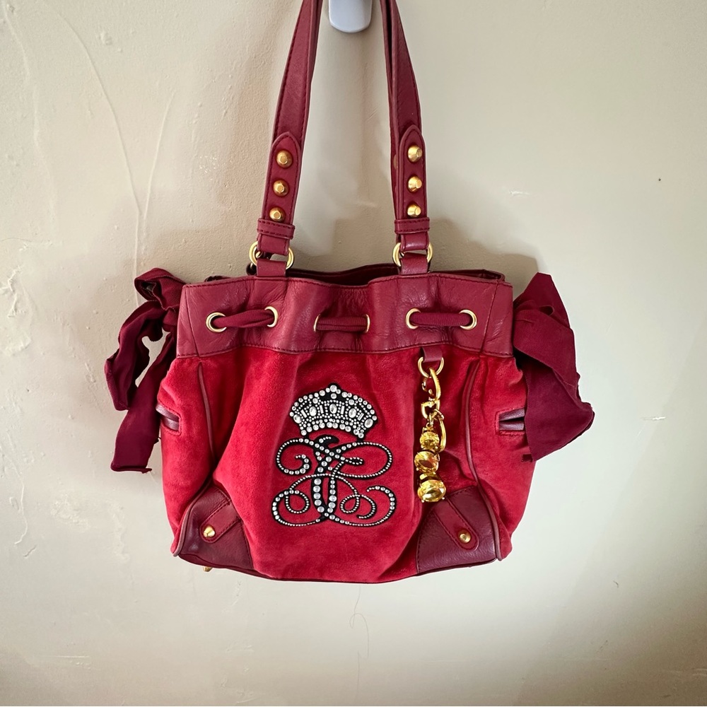 Red leather and velvet Juicy Couture bag with and gold crystal charm keychain.